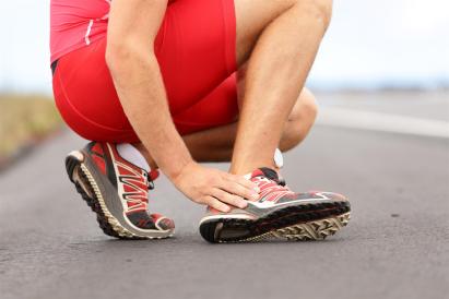 Runner grabbing her ankle