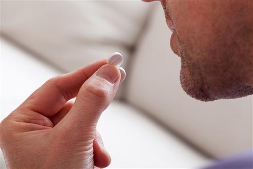 Man holding pill