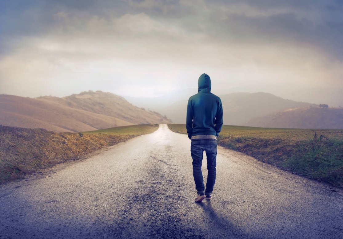 Person walking down deserted road