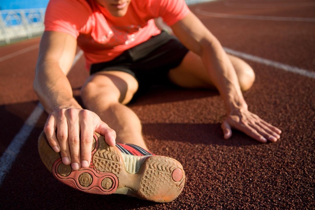 Athlete Stretching Legs